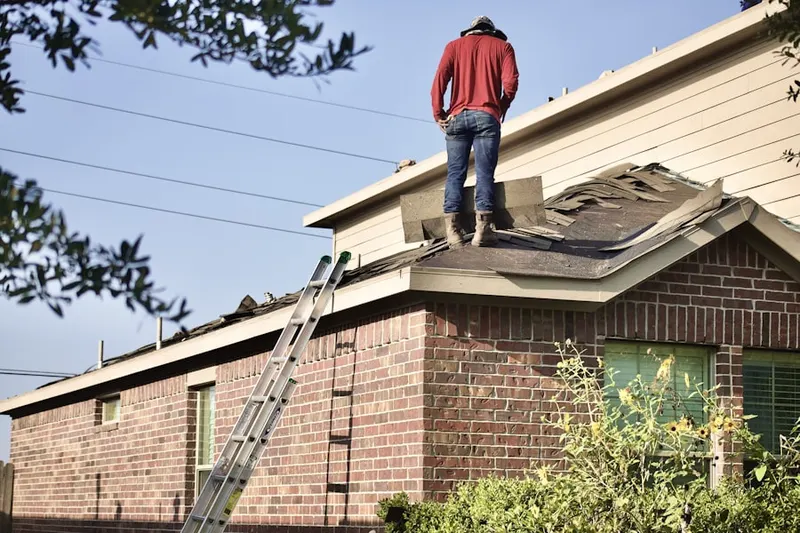 Professional roofer working on a residential roof in Westmoor Acres